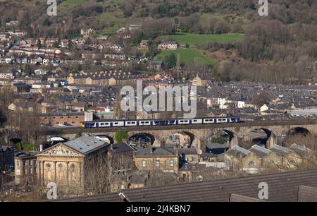 Todmorden Viaduct, Yorkshire, UK Northern Rail class 150 trains crossing above the roof tops  passing  the town hall Stock Photo