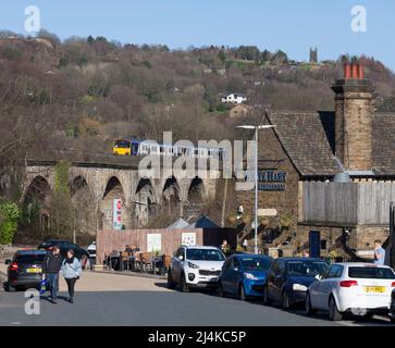 Todmorden Viaduct, Yorkshire, UK Northern Rail class 150 trains crossing passing a Weatherspoons pub Stock Photo