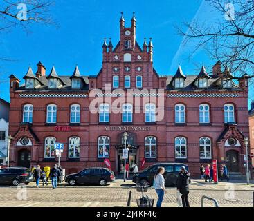 Neumuenster, Germany - 16. April 2022: The historical building of the old post office with a ReWe supermarket in Neumuenster, Germany Stock Photo