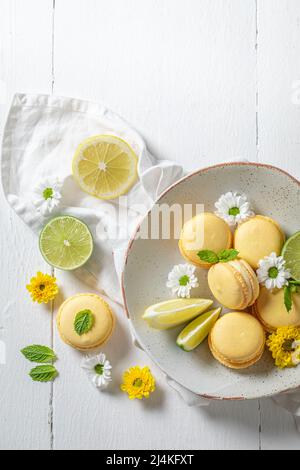 Tasty and sweet lemon macaroons as a spring snack. Yellow macaroons made of citrus. Stock Photo