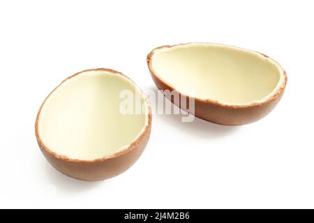 Two halves of milk chocolate egg isolated on white background. Stock Photo