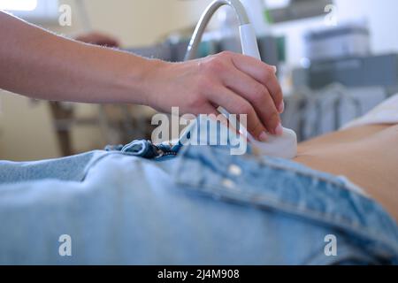 Ultrasound of uterus in early pregnancy to woman in clinic Stock Photo