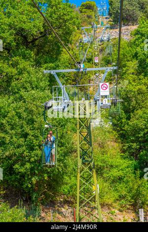 People are enjoying ride at Funivia Colle Eletto in Gubbio, Italy Stock ...