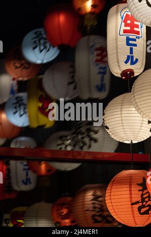 Chinese paper lanterns lamps in stylish cafe. China restaurant decorations for interior design Stock Photo