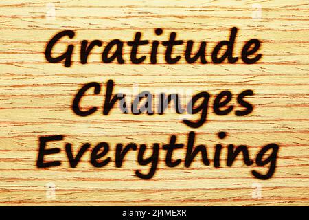 Handwritten motivational message Gratitude Changes Everything burnt on wood. Concept about gratefulness, thankfulness, and appreciation. Stock Photo