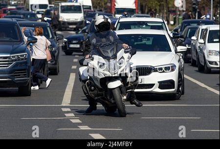 Bucharest, Romania - April 06, 2022: A policeman sitting on BMW R 1200 RT authority motorcycles, waiting at red traffic lights, in Bucharest. This ima Stock Photo