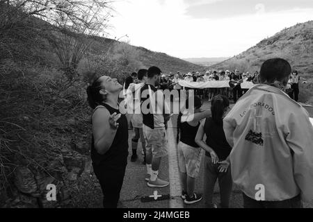 Tucson, Arizona, USA. 15th Apr, 2022. Good Friday cross procession up Sentinal Peak in Tucson. Several hundred people take turns carrying a large wooden cross to the top of A Mountain. It is sponsored by the Dorados Orphan League. which culminates in a sunrise mass on Easter Sunday. The annual event was returning after a two year hiatus due to the pandemic. (Credit Image: © Christopher Brown/ZUMA Press Wire) Stock Photo