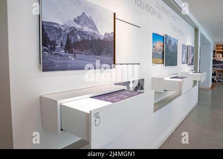 Interior of modern museum decorated with various paintings hanging on wall Stock Photo