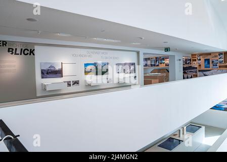 Interior of modern museum decorated with various paintings hanging on wall Stock Photo