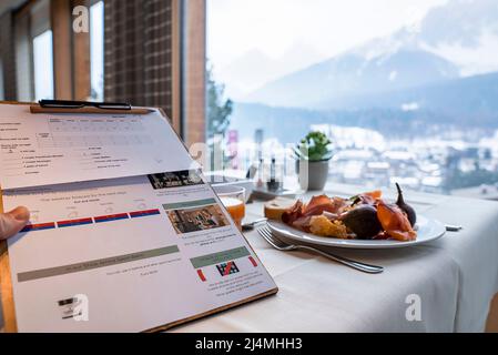 Clipboard with healthy fresh vegetables served in plate on table at hotel Stock Photo
