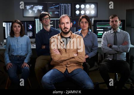 Serious faces confident diverse business people office workers team in row looking at camera. Caucasian professional employees executives group posing Stock Photo