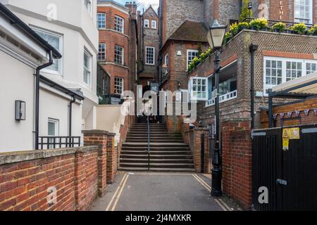 An alleyway leading up steps towards Thames Street leading on from The Queen's Walkway in Windsor, UK Stock Photo