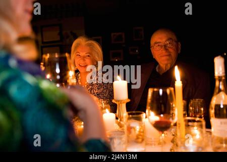 Mature couple at dinner party with friends Stock Photo