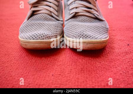 old style shoes, vintage style shoes on isolated red ground and carpet background. Stock Photo