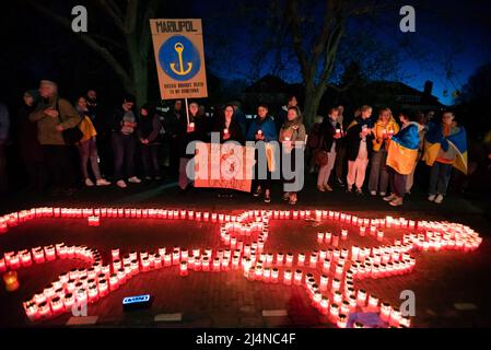 Protesters gather in silence, facing 500 candles outside the Russian embassy, during a ‘Silent Evening Wake' to those lost in Russia's invasion of Ukraine. Each day there is a continuous silent demonstration in front of the Russian embassy in The Hague, sometimes songs are sung. A large Ukrainian flag hangs in front all day. People from churches in The Hague gather there during their lunch break, between the hour 12.30 and 1 p.m. to commemorate the recently fallen in Ukraine. This evening, around a hundred protesters gathered outside the embassy, some with placards and a banner, and some drape Stock Photo