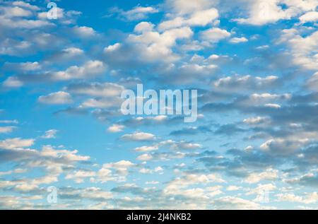 Puffy white clouds on a blue sky early in the morning over the Southern California desert. Stock Photo