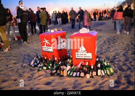 Hamburg, Germany. 16th Apr, 2022. Dozens of empty beer bottles and beverage cans stand around two trash cans near an Easter bonfire on the Elbe River. In many places, the traditional bonfires could take place again for the first time after a break due to Corona. Credit: Jonas Walzberg/dpa/Alamy Live News Stock Photo