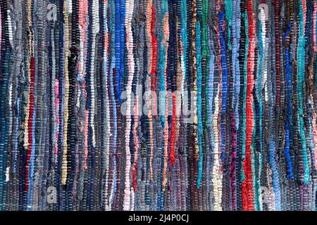 Multicolored handmade floor rug made out of recycled rags as background Stock Photo