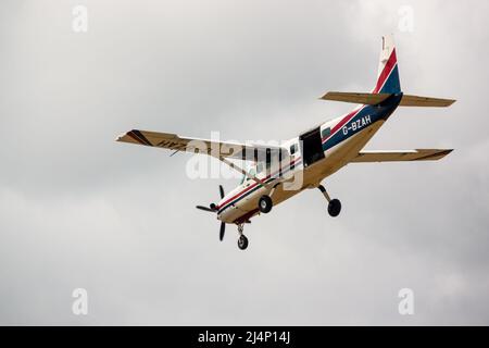 Cessna 208b Grand Caravan G-BZAH light aircraft descending to land Stock Photo