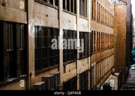 Facade of old factory building built from bricks in a backstreet alley Stock Photo