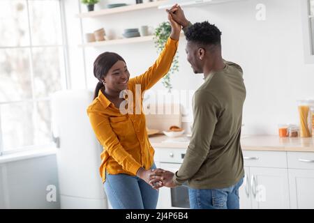 Portrait Of Joyful Black Millennial Couple Having Fun In Kitchen Interior Stock Photo