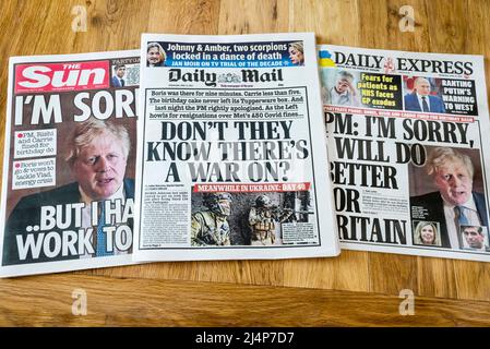 Sun, Daily Mail and Daily Express headlines on 13 April 2022 supporting Boris Johnson over the partygate scandal, following the issue of police fines. Stock Photo