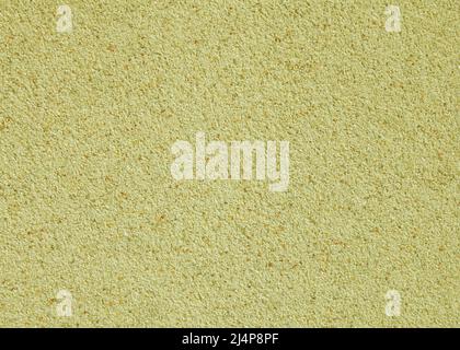 Abstract wall background. Yellow plaster with mosaic pattern. Light surface with a chaotic loose pattern. Mosaic and granulated textured coating Stock Photo