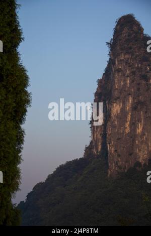 Moon next to cliff face near yangshuo china Stock Photo