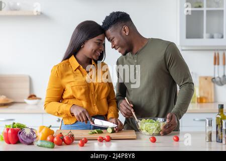 Happy African American Spouses Bonding In Kitchen While Preparing Healthy Lunch Together Stock Photo