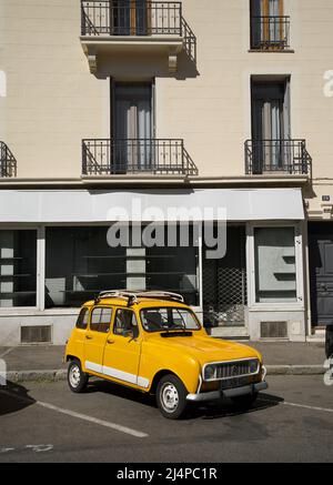 Yellow Orange Renault 4 GTL - Classic French car parked in front of a shop in a French town. Stock Photo