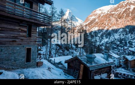 Scenic view of ski resort in town overlooking Matterhorn mountain during winter Stock Photo