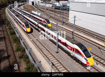 Aerial view of Hitachi Azuma Class 800 Bi Modal passenger trains under overhead electric wires on Hitachi Rail Europe maintenance depot in Doncaster Stock Photo