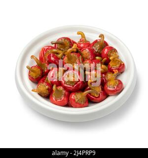 Bowl with pickled spicy Red Cherry chile peppers close up isolated on white background Stock Photo
