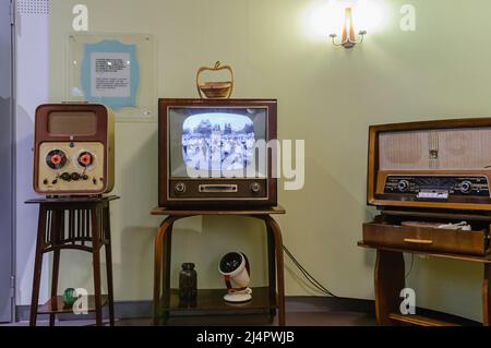 Reel to Reel player, black and white television and an old medium/long wave radio in a living room from the 1950s. Stock Photo