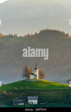 The Church of St. Tomaz on top of a hill at a beautiful sunrise in the fall, near Skofja Loka in the Upper Carniola region of Slovenia. Stock Photo