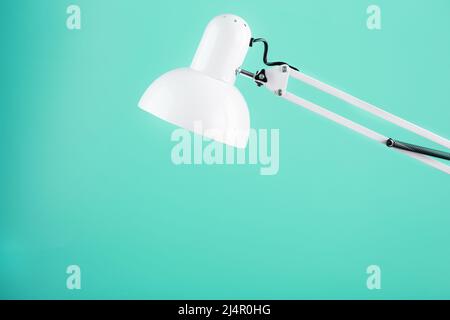 White table office lamp on green background with space for text and idea concept Stock Photo