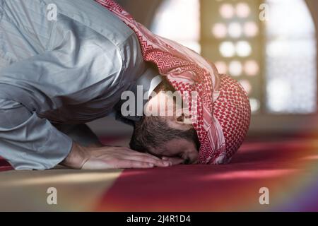 Muslim Arabic man praying. Religious muslim man praying inside the mosque during ramadan Stock Photo
