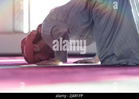 Muslim Arabic man praying. Religious muslim man praying inside the mosque during ramadan Stock Photo
