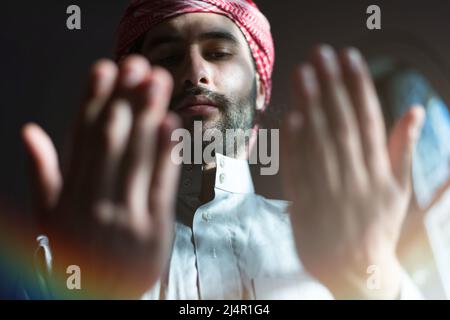 Muslim Arabic man praying. Religious muslim man praying inside the mosque during ramadan Stock Photo