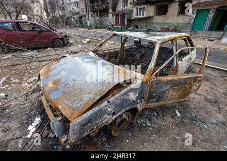 Irpen city, Ukraine, April 11, 2022. War of Russia against Ukraine. Burnt out car in the yard of a residential building Stock Photo