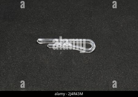 plastic paper clip. on a black background Stock Photo