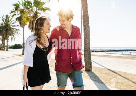 Happy couple in love walking together while enjoying their summer vacation. Stock Photo