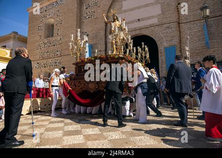 Almunecar, Spain. 17th April 2022. Easter Holy Week, Semana Santa,  in Almuñécar, declared of National Tourist Interest in Andalusia, fills the streets of the municipality with tradition and heartfelt devotion each year. This is the Easter Sunday procession the final day of Holy Week. It commemorates the Catholic festival of the Resurrection of Jesus Christ. brotherhoods organize the processions that go through the streets and squares carrying beautiful thrones adorned with flowers and religious images that are carried by the forks. Credit David Smith/Alamy Live News Stock Photo