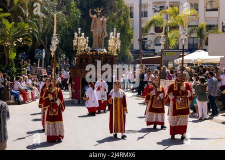 Almunecar, Spain. 17th April 2022. Easter Holy Week, Semana Santa,  in Almuñécar, declared of National Tourist Interest in Andalusia, fills the streets of the municipality with tradition and heartfelt devotion each year. This is the Easter Sunday procession the final day of Holy Week. It commemorates the Catholic festival of the Resurrection of Jesus Christ. brotherhoods organize the processions that go through the streets and squares carrying beautiful thrones adorned with flowers and religious images that are carried by the forks. Credit David Smith/Alamy Live News Stock Photo