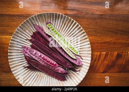 Pile of Guaje seed pods on a plate in Oaxaca, Mexico Stock Photo