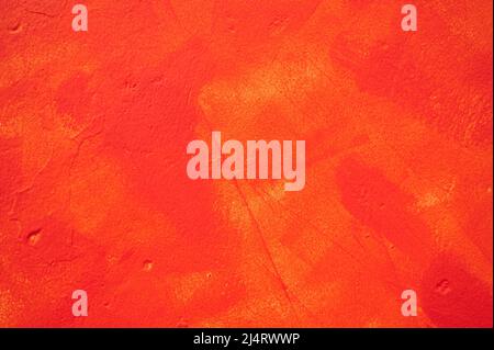 detail of an irregular stucco wall painted red or orange Stock Photo