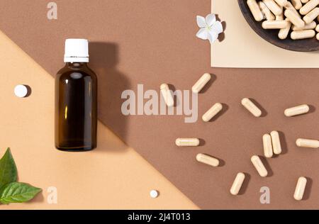 Flat lay composition of various dietary supplements on brown background. Vitamin complexes concept. Stock Photo