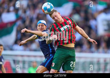 Andre HAHN, FCA 28  compete for the ball, tackling, duel, header, zweikampf, action, fight against Santiago ASCACIBAR, Hertha 18  in the match FC AUGSBURG - HERTHA BSC BERLIN 0-1 1.German Football League on April 16, 2022 in Augsburg, Germany  Season 2021/2022, matchday 30, 1.Bundesliga, 30.Spieltag. © Peter Schatz / Alamy Live News    - DFL REGULATIONS PROHIBIT ANY USE OF PHOTOGRAPHS as IMAGE SEQUENCES and/or QUASI-VIDEO - Stock Photo