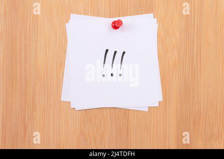 White Sticky Notes with Three Exclamation Points Pinned to the Wooden Message Board. To Do List Reminder in the Office. Memo Note at Work Stock Photo
