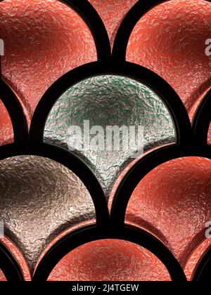 An abstract pattern on a colored window through which a light shines Stock Photo